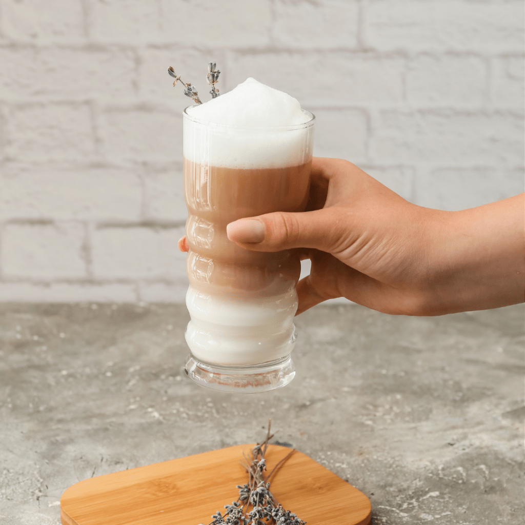woman holding lavender latte with foam kitchen food photography